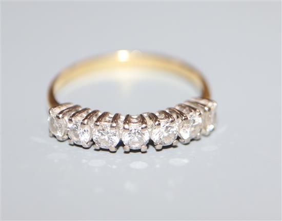 An 18ct and seven stone diamond half hoop ring, size K.